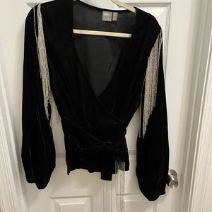 Black velvet wrap top with silver fringe on sleeves and belt.
